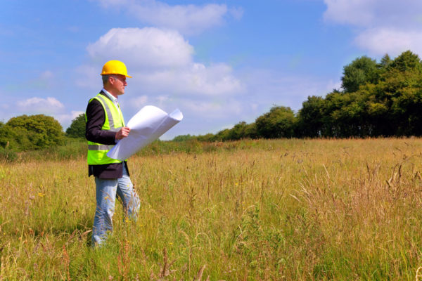 man surveying land development zone